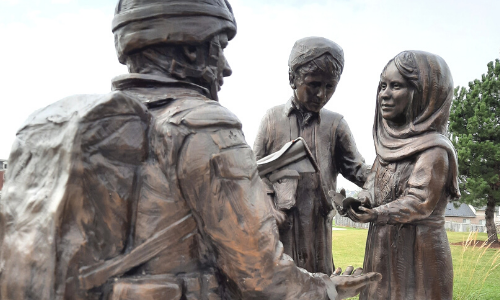 Sculpture of solider with two children